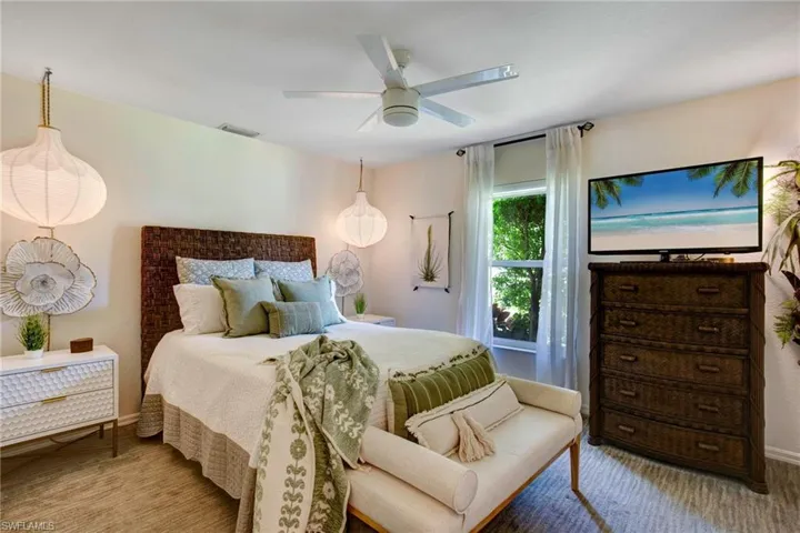 Carpeted bedroom with ceiling fan