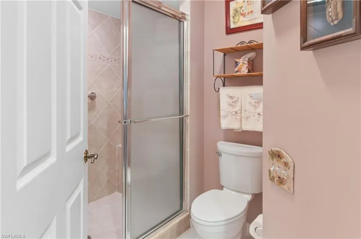Primary bathroom with toilet and a stall shower