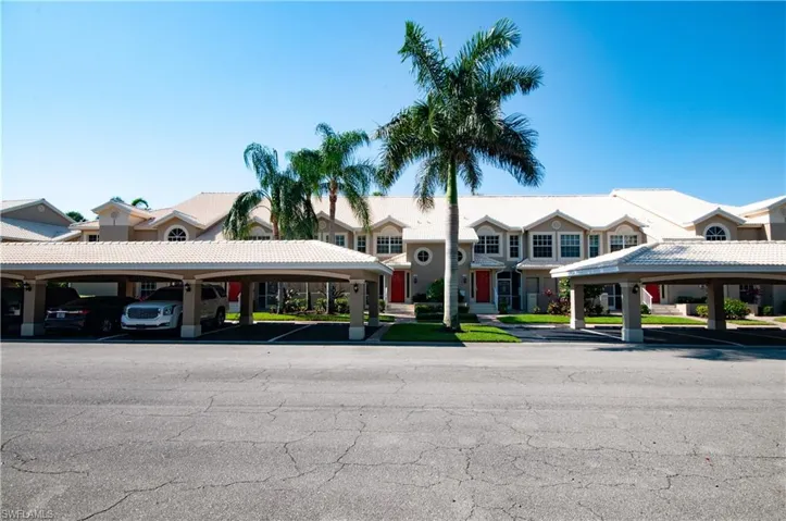 View of property featuring covered parking, owners get 1 private parking space under carports with plenty of guest parking across from carports