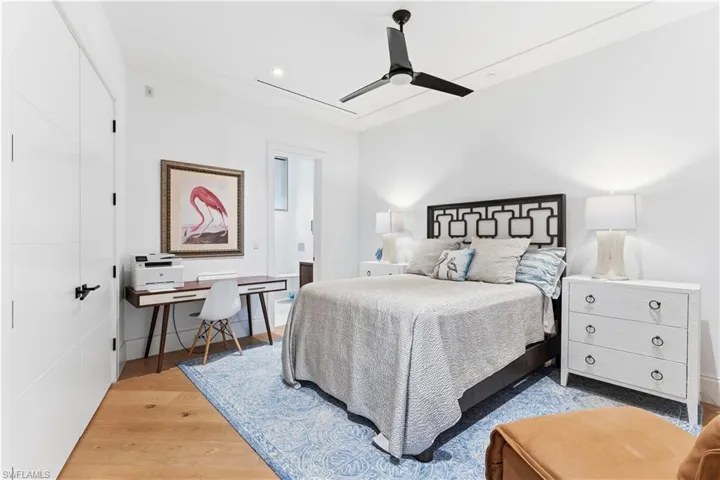 Bedroom with a ceiling fan, a closet, light wood finished floors, a desk, and recessed lighting