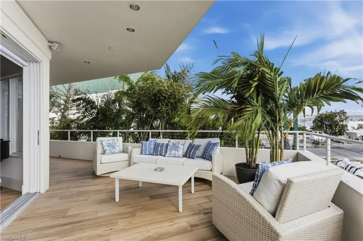 View of wooden balcony featuring an outdoor hangout area and a deck