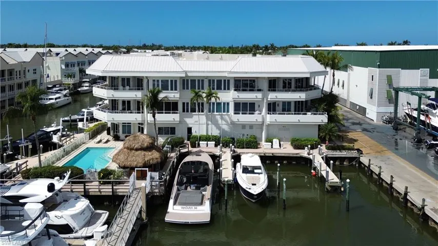 Dock with a water view and a community pool