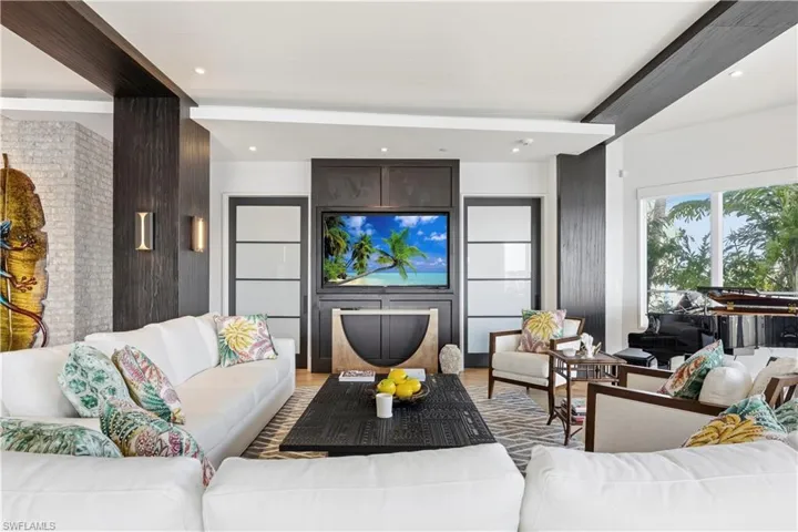 Living room with light wood-style flooring and recessed lighting