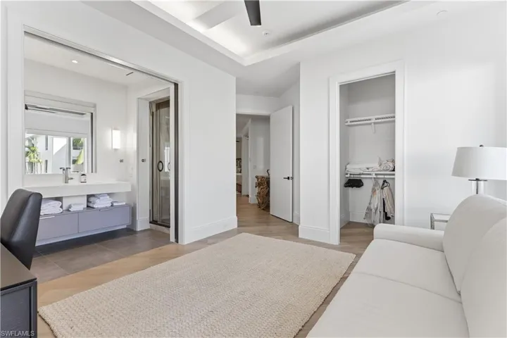 Bedroom featuring light wood-style flooring, a closet, a ceiling fan, and recessed lighting