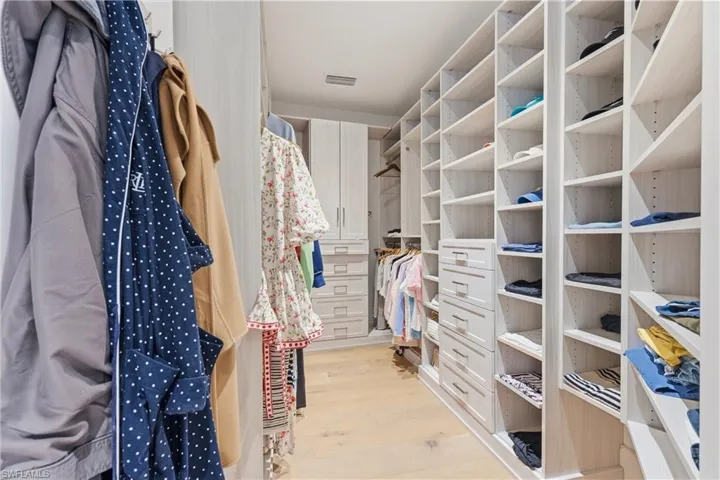 Walk in closet featuring light wood-style floors