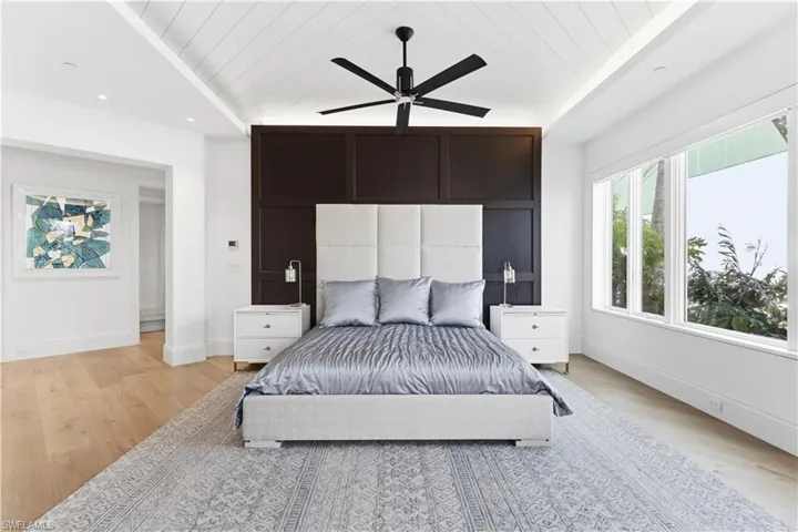 Bedroom with wooden ceiling, light wood finished floors, ceiling fan, and recessed lighting