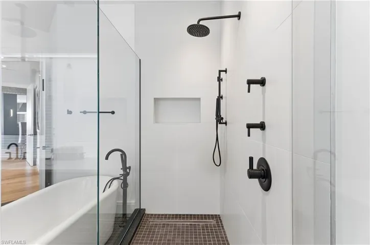 Bathroom with a stall shower and a freestanding tub