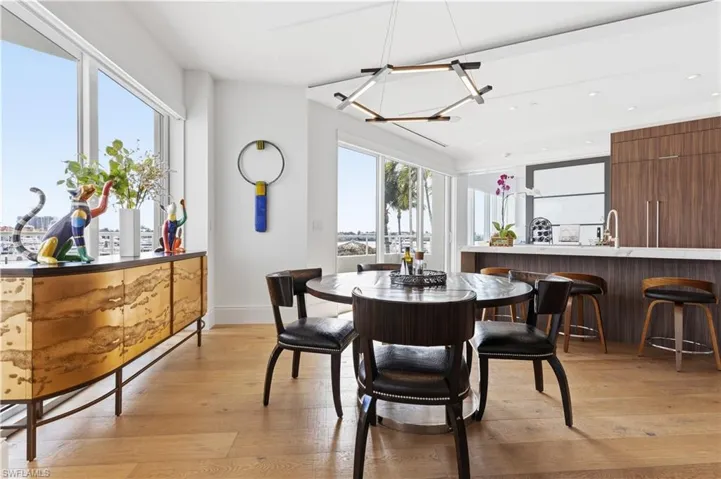 Dining space with light wood-type flooring and hanging lights