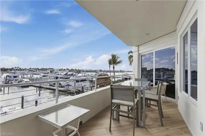 Balcony with a water view and view of marina