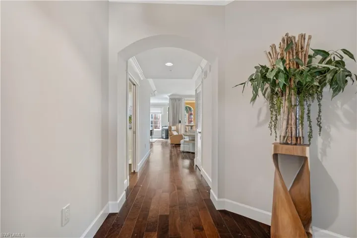 Hallway with dark wood-type flooring