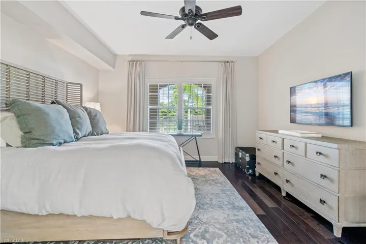 Bedroom featuring ceiling fan and dark hardwood / wood-style floors