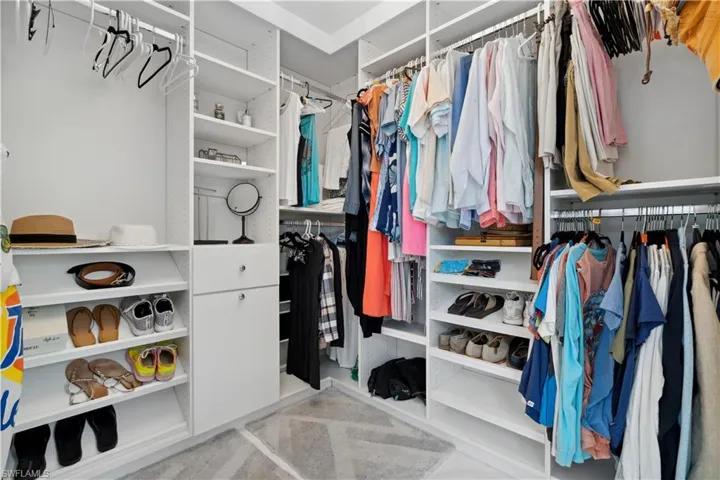 Walk in closet with light carpet