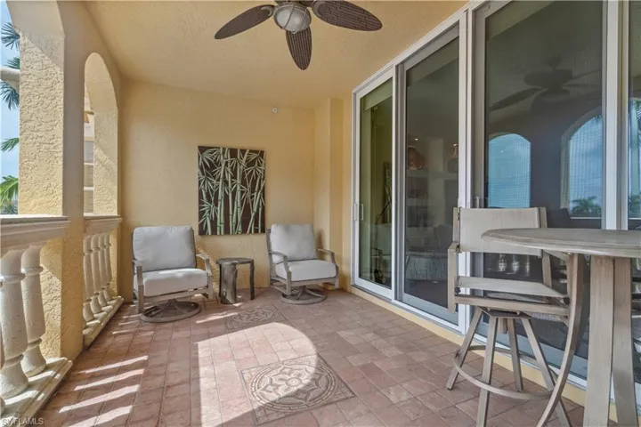 Balcony featuring ceiling fan and a patio area