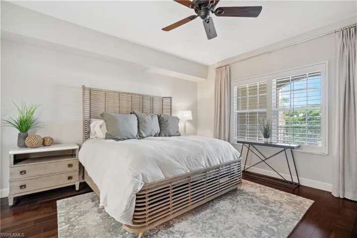 Bedroom featuring ceiling fan and dark hardwood / wood-style flooring