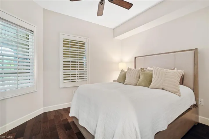 Bedroom featuring dark hardwood / wood-style flooring and ceiling fan