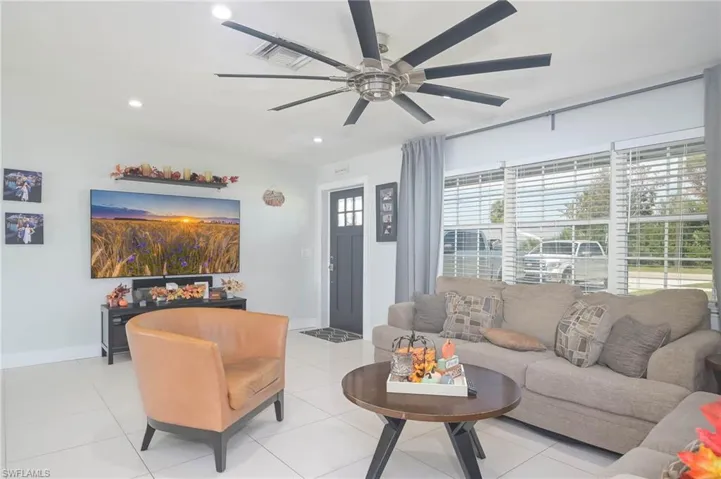 Tiled living room featuring ceiling fan
