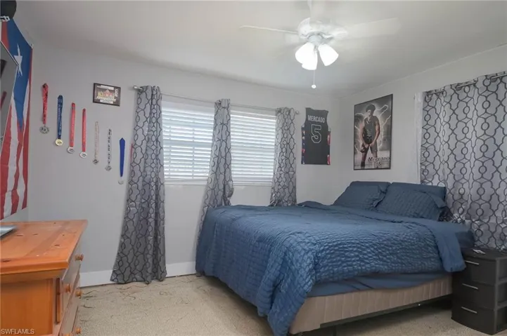 Bedroom featuring light carpet and ceiling fan