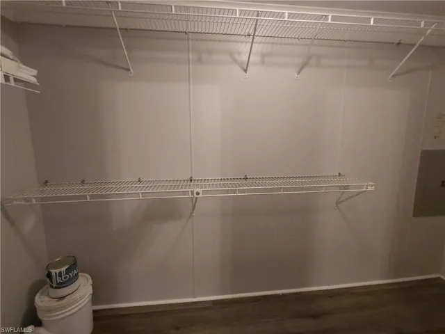 Walk in closet featuring dark wood-type flooring and electric panel
