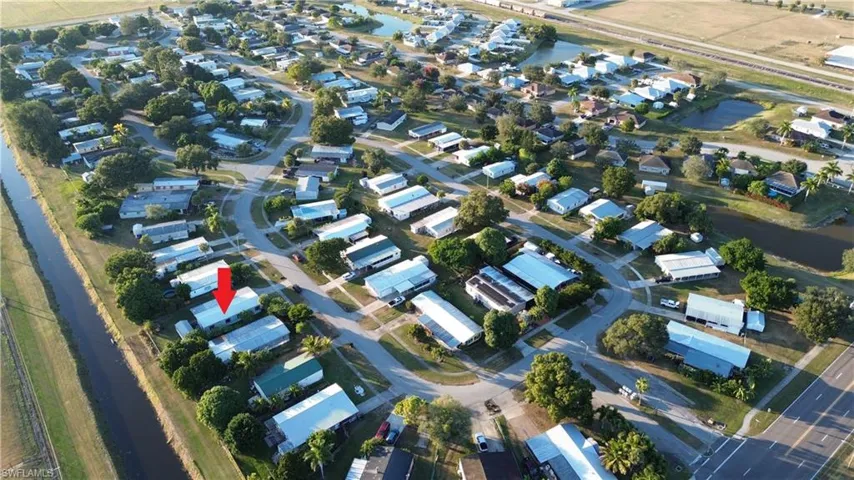 Aerial view of property's location featuring nearby suburban area and a nearby body of water