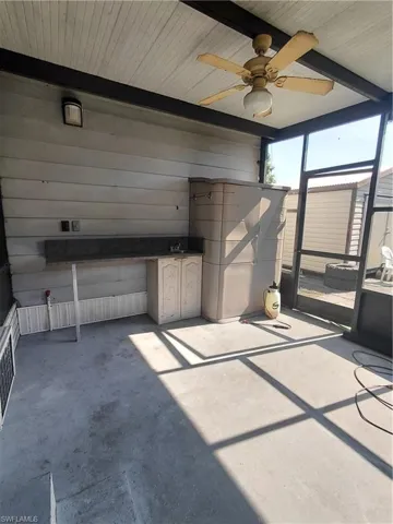 View of patio with a sunroom and ceiling fan
