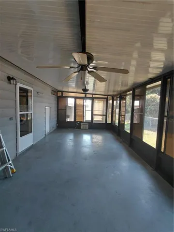 Unfurnished sunroom with a ceiling fan