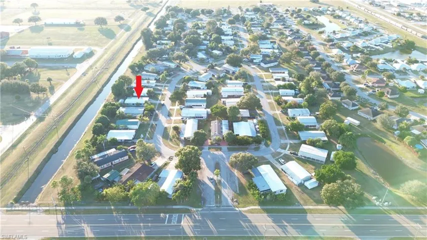 Aerial view of property's location with nearby suburban area