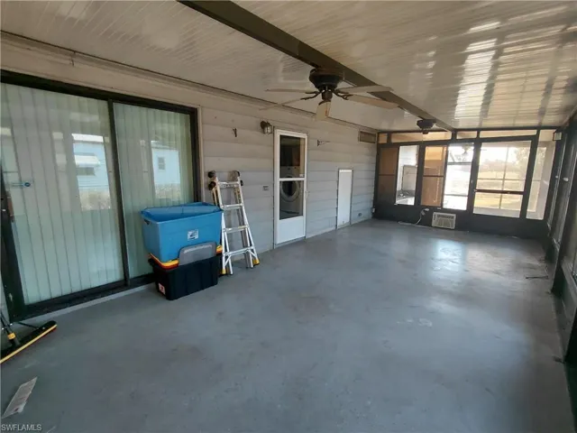 Unfurnished sunroom with a ceiling fan