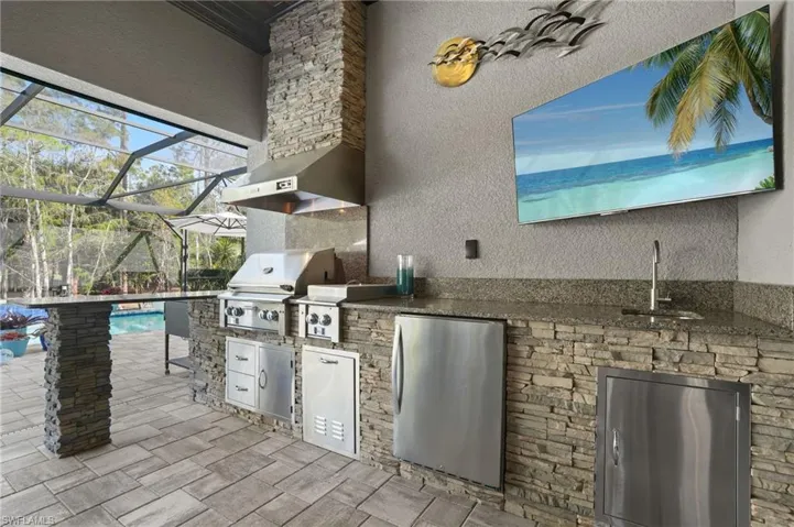 Well-equipped outdoor kitchen with gas grill.