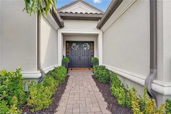 Doorway to property with stucco siding
