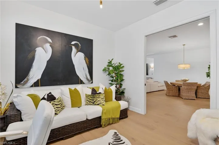 Living room with wood finished floors and recessed lighting