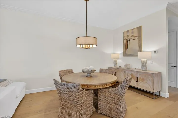 Dining room featuring crown molding and light wood finished floors