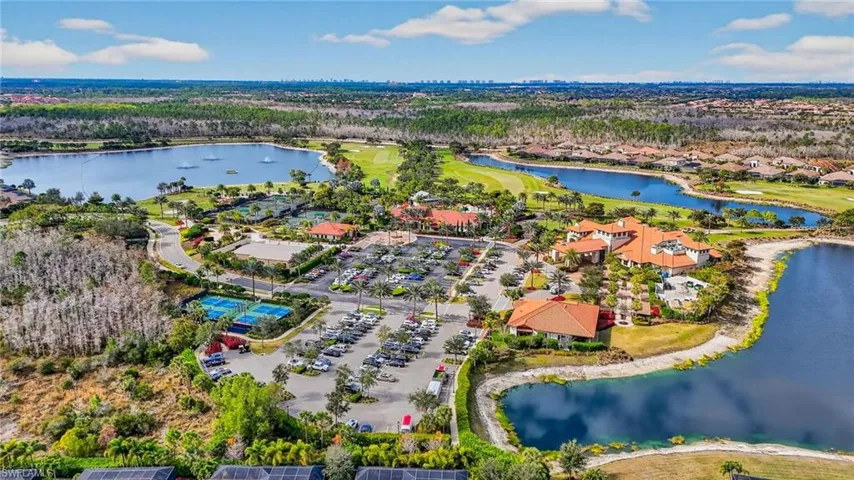 Aerial view of residential area with a large body of water and a local golf course