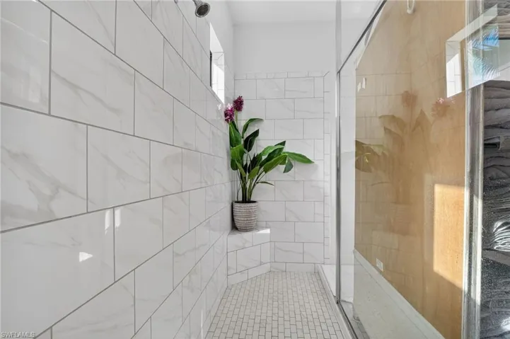 Full bathroom with a shower stall