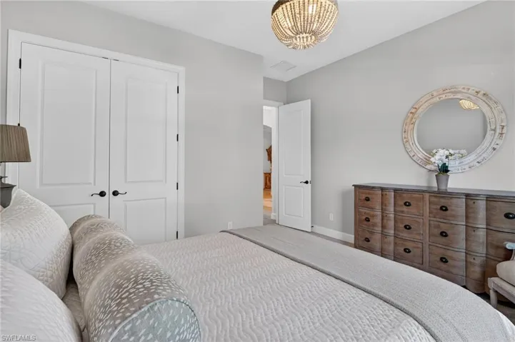 Bedroom with a closet and hanging lights