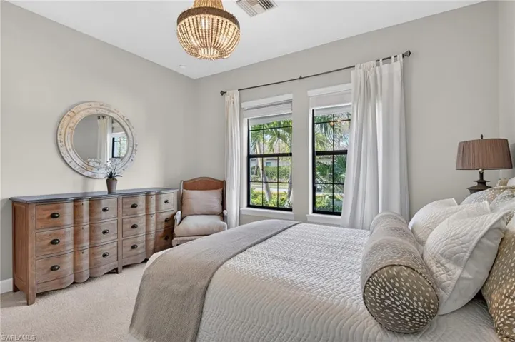 Bedroom with carpet and suspended lighting
