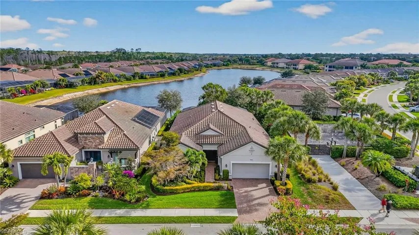 Aerial perspective of suburban area featuring a large body of water