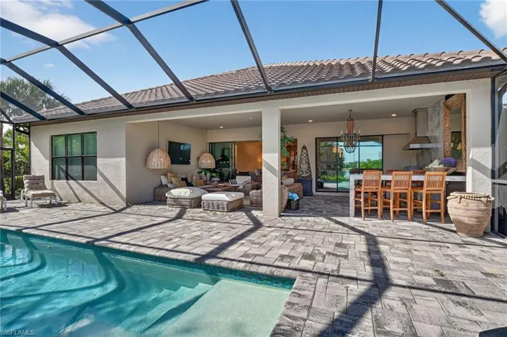 Back of house featuring stucco siding, a sunroom, and glass enclosure