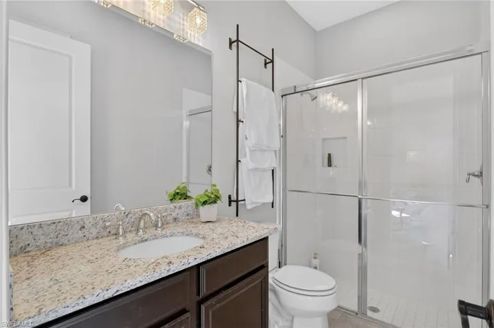 Bathroom featuring a stall shower and vanity