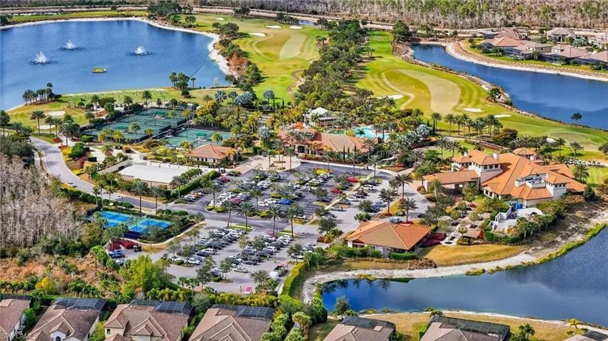 View of property location featuring a large body of water, nearby suburban area, and a golf club