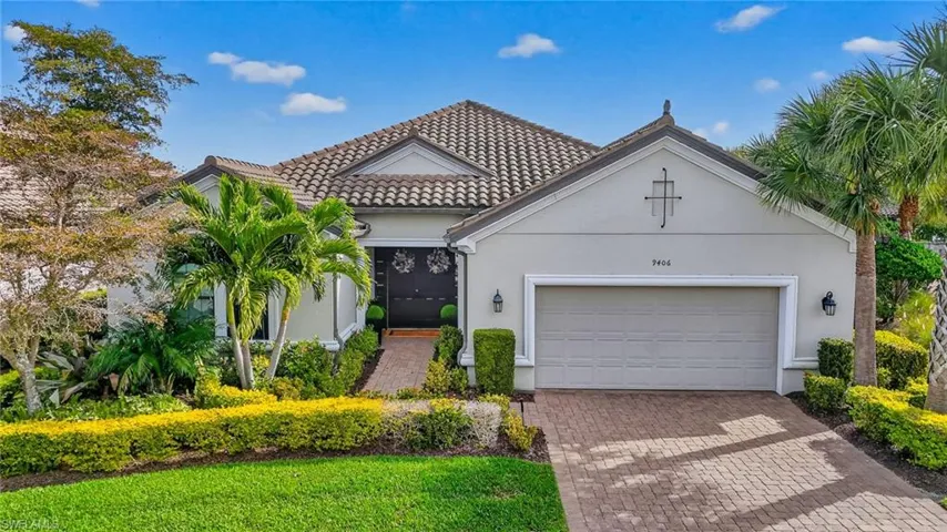 Mediterranean / spanish-style home with stucco siding, decorative driveway, an attached garage, and a tiled roof
