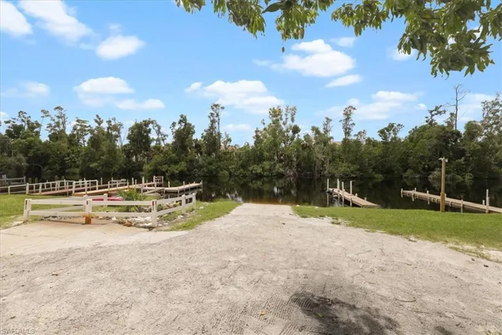 View of property's community with a boat ramp and a dock