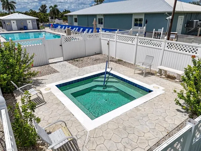 Community pool featuring a patio area and a hot tub