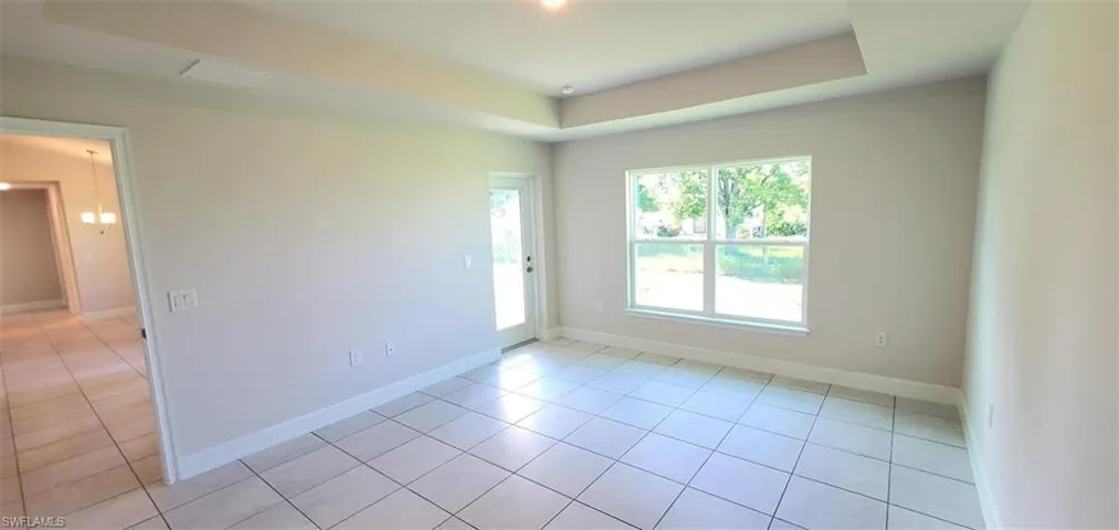 Primary Bedroom with light tile patterned flooring