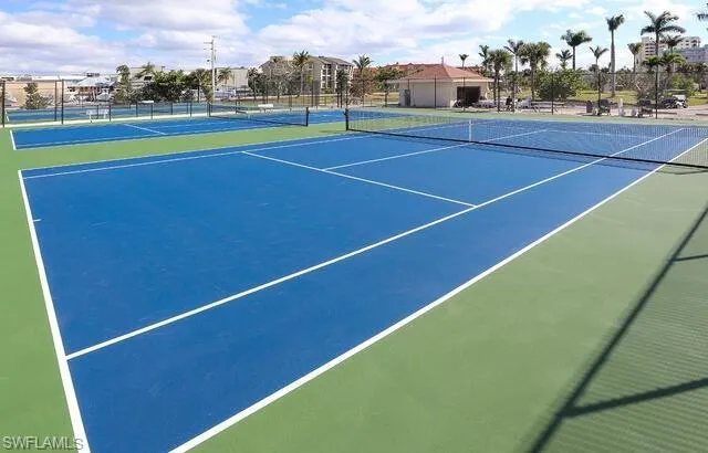 View of tennis court with community basketball court