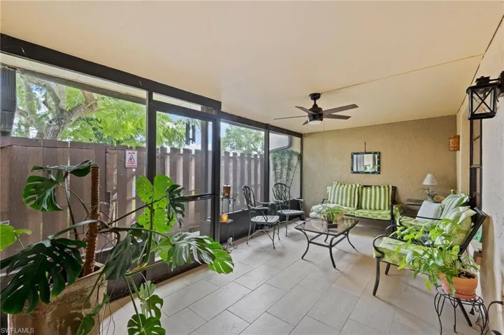 Sunroom with a healthy amount of sunlight and ceiling fan