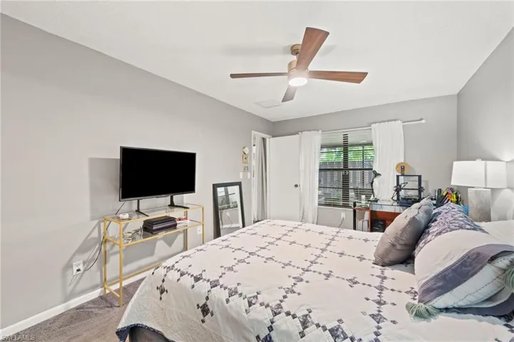 Carpeted bedroom with ceiling fan