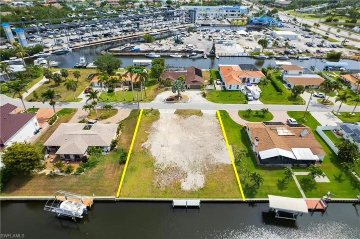 Aerial view of property and surrounding area with a large body of water and property parcel outlined