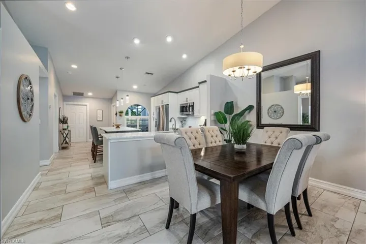 Dining space featuring lofted ceiling and a notable chandelier