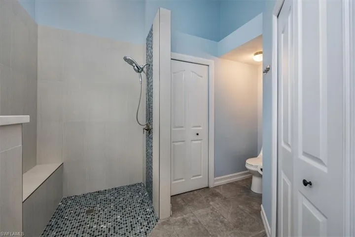 Master Bathroom featuring a tile shower, and tile patterned floors