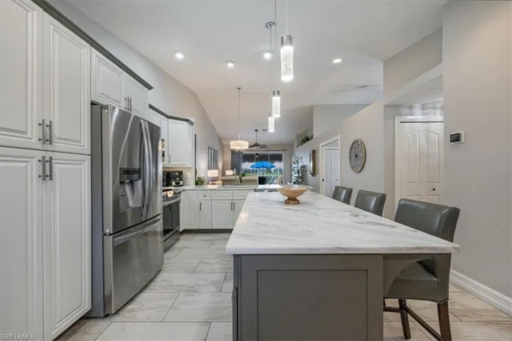 Renovated Kitchen with a island, stainless steel appliances, and decorative light fixtures